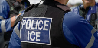 An agent with a jacket reading "Police ICE"