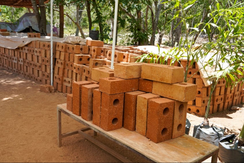 piles of sarga-block, a brick-like building material made out of sargassum seaweed