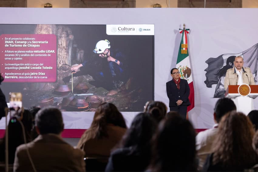 INAH Director Joel Omar Vázquez shares a slide showing an archaeologist in a Chiapas cave