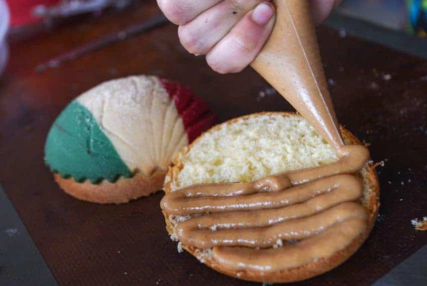 A sweet bread being decorated in Mexico City