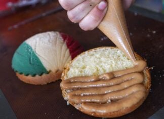 A pastry chef puts the finishing touch on patriotic sweet bread.