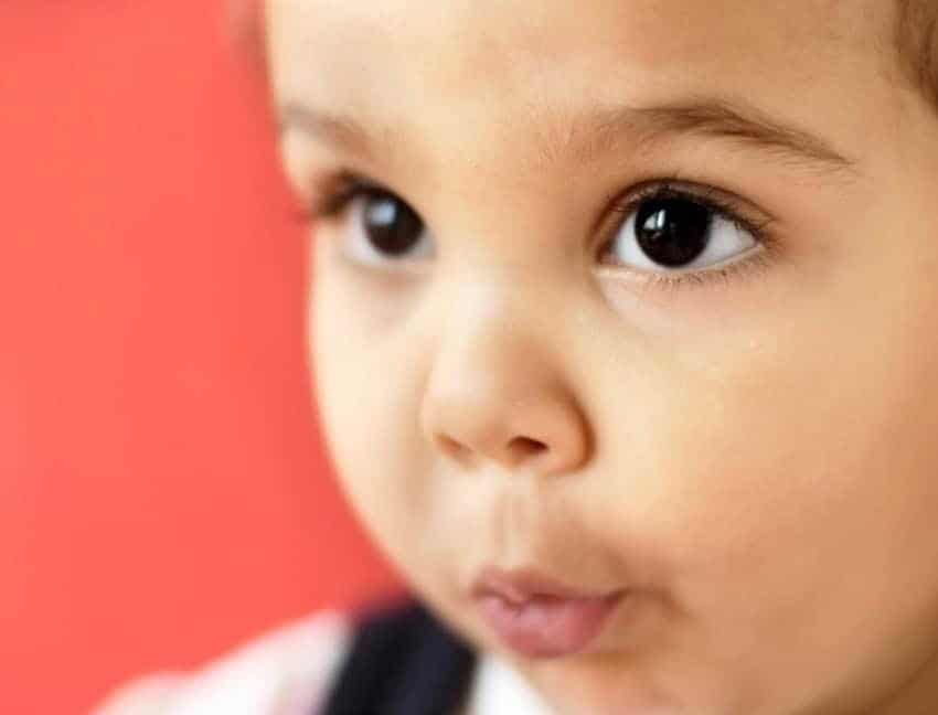 Child puckering his lips to whistle