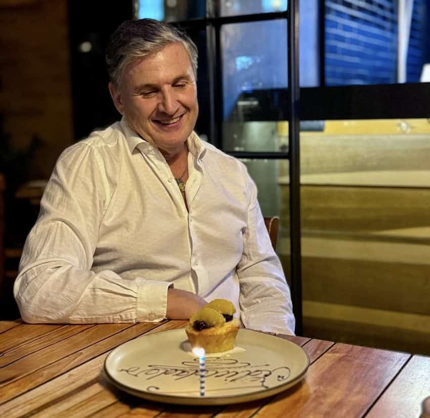 A man stares at a birthday cake