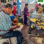 A man serves elote, or roasted corn on the cob, in San Miguel de Allende, Mexico.