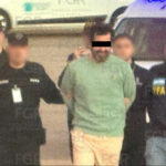 Ex-Navy rear admiral Fernando Farías, handcuffed, accompanied by five federal agents