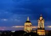 Summer evenings in San Miguel highlight church towers and other historic buildings backed by lingering sunsets.