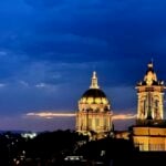Summer evenings in San Miguel highlight church towers and other historic buildings backed by lingering sunsets.