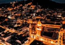 Aerial view of Parroquia Nuestra Señora de Guadalupe in Puerto Vallarta at night.