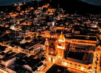 Aerial view of Parroquia Nuestra Señora de Guadalupe in Puerto Vallarta at night.
