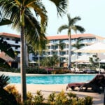 View of pool, hotel and palm trees at an all-inclusive resort in Cancún
