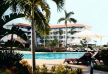 View of pool, hotel and palm trees at an all-inclusive resort in Cancún