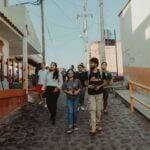 A group of tourists walking through a charming village in Mexico