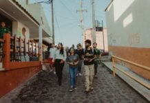 A group of tourists walking through a charming village in Mexico