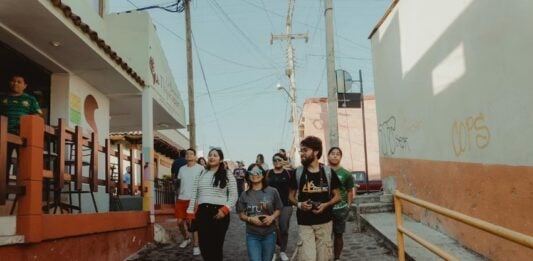 A group of tourists walking through a charming village in Mexico