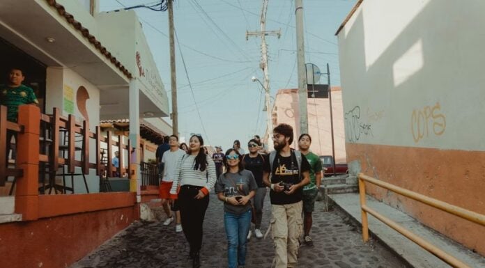 A group of tourists walking through a charming village in Mexico