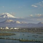 A visual reimagining of the ancient city with mountains in the background