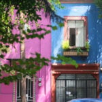 Closeup of building facades on a tree-lined street in Mexico City.
