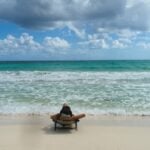person lying looking at a Tulum beach