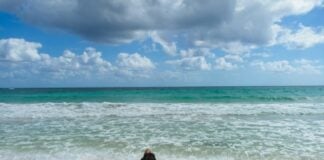 person lying looking at a Tulum beach