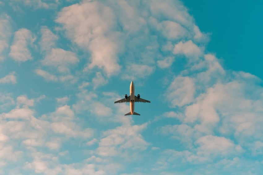 Plane flying overhead surrounded by clouds