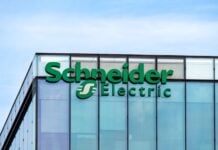 Rueil-Malmaison, France - August 13, 2023: Sign and logo on the headquarters building of Schneider Electric, a French multinational company specializing in digital automation and energy management