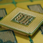 Macro shot of CPU showing grid array of contact pins for motherboard fitting
