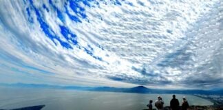 Hikers enjoy the view of Lake Chapala from the glider launch point