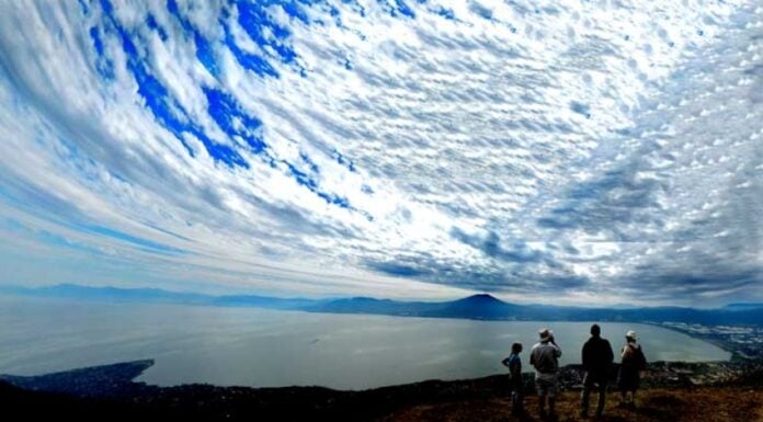 Hikers enjoy the view of Lake Chapala from the glider launch point