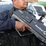 officer holding anti drone equipment