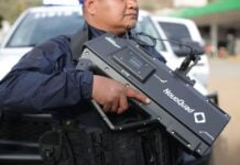 officer holding anti drone equipment