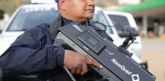 officer holding anti drone equipment