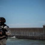 National Guard troops patrol the beach along the U.S. border wall in Tijuana in February.