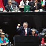 Alejandro Moreno, leader of Mexico's PRI party, speaking at a podium during a congressional session in Mexico City.