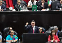 Alejandro Moreno, leader of Mexico's PRI party, speaking at a podium during a congressional session in Mexico City.