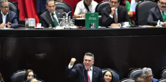 Alejandro Moreno, leader of Mexico's PRI party, speaking at a podium during a congressional session in Mexico City.