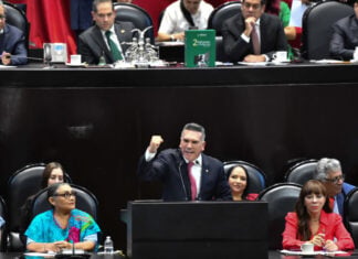 Alejandro Moreno, leader of Mexico's PRI party, speaking at a podium during a congressional session in Mexico City.