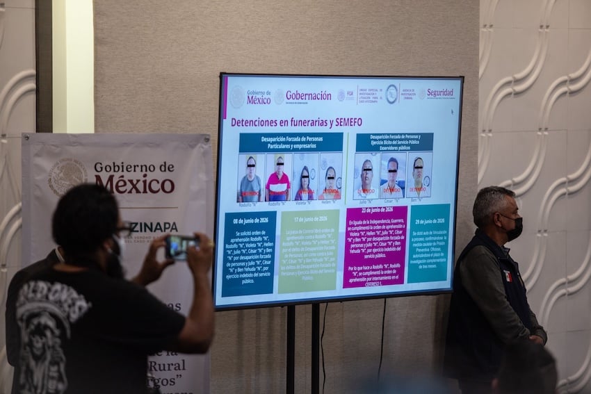 On a screen, Mexican authorities present several new suspects in the Ayotzinapa investigation