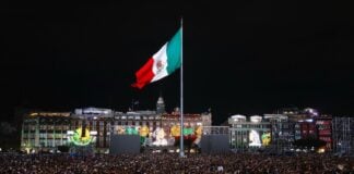 Mexico flag flying high from the Zócalo