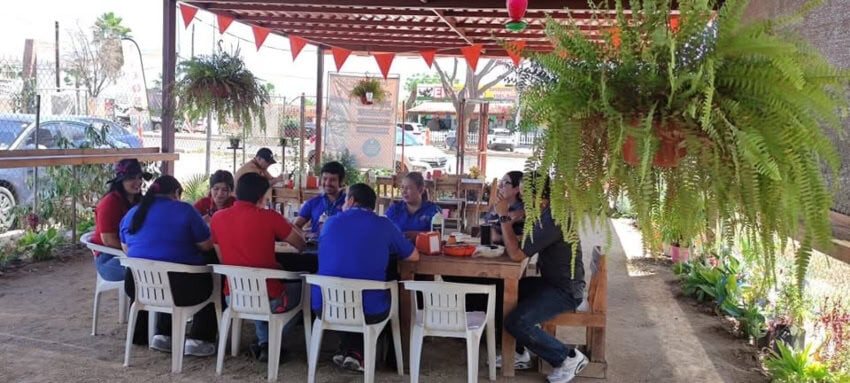 taquería in Mexico with guests sitting on white plastic chairs