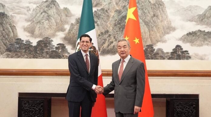 Mexico's Foreign Affairs Minister Roberto Velasco shakes hands with his Chinese counterpart Wang Yi in Beijing