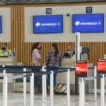Passengers check in for a flight at the Aeroméxico ticket counter at Felipe Ángeles International Airport (AIFA).
