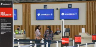Passengers check in for a flight at the Aeroméxico ticket counter at Felipe Ángeles International Airport (AIFA).