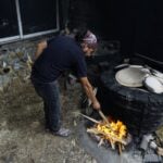 Oaxacan potter stokes the fire for pottery-making in Santa María Atzompa.