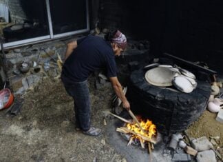 Oaxacan potter stokes the fire for pottery-making in Santa María Atzompa.
