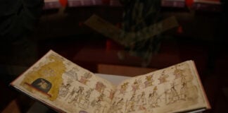 The yellowed pages of the Azcatitlan Codex, showing illustrations of Indigenous people in a line under a pyramid and columns bearing a variety of symbols