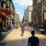 Mexico City, with a man with his back to the camera staring out at a colorful scene
