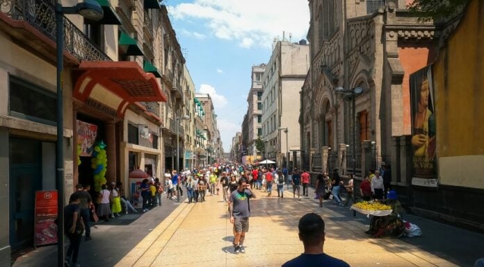 Mexico City, with a man with his back to the camera staring out at a colorful scene