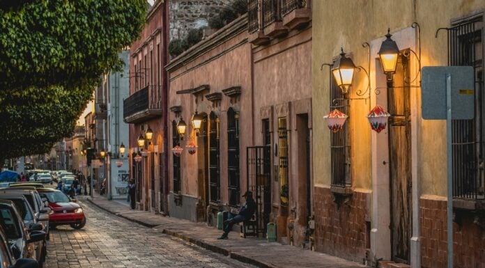 Santiago de Querétaro street scene, with car pulling out from a narrow block filled with residential housing.