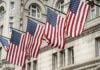 Flags flying in front of a U.S. building