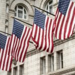 Flags flying in front of a U.S. building
